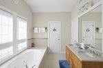 Master bath with Jacuzzi tub, double vanity and separate water closet with toilet and shower